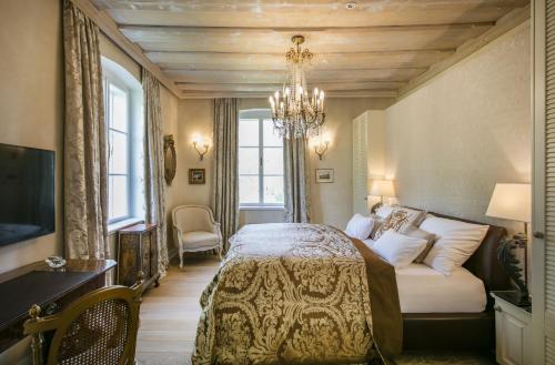 1 dormitorio con cama y lámpara de araña en Villa Rosen der Villa Liechtenstein, en Altaussee