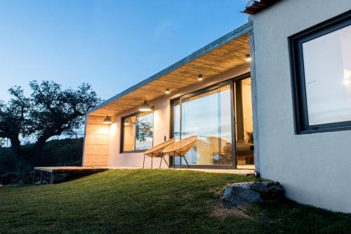 a house with a table on the side of it at Vigias -Eternal Landscapes in Marvão