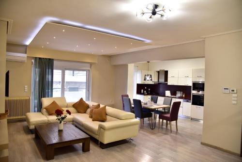 a living room and kitchen with a couch and a table at Gtrip Piraeus Floor Apartment - 8324 in Piraeus