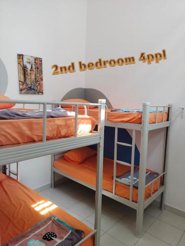 a dorm room with two bunk beds and a sign at SSR312/S2TOWN/3R2B HOMESTAY in Seremban