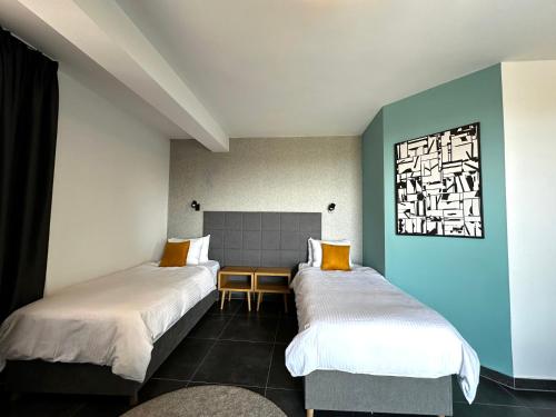 two beds in a room with blue and white walls at La Vista Luxury Villa in Ohrid