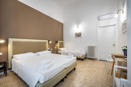 um quarto com duas camas e um lavatório. em la loggia del porcellino em Florença