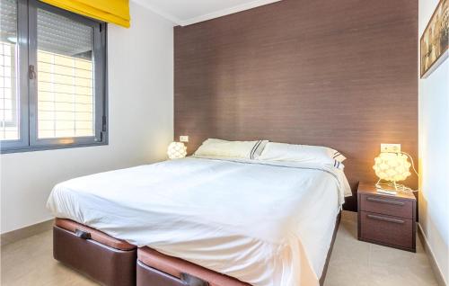 sypialnia z dużym łóżkiem i drewnianą ścianą w obiekcie Nice Apartment In Campello With Wi-fi w mieście La Venteta