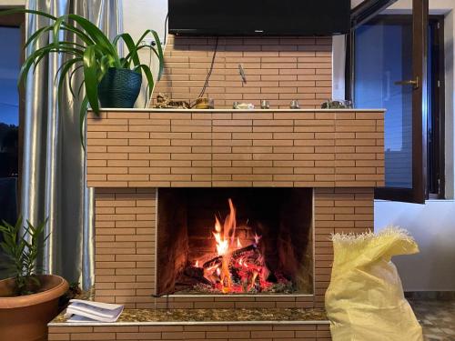 a brick fireplace with a fire in it at Villa in Bakuriani in Bakuriani