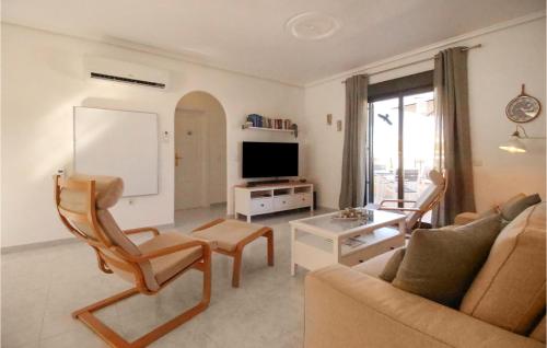 a living room with a couch and a table at 2 Bedroom Stunning Apartment In Rojales in Rojales