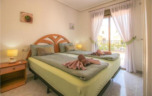 a bedroom with two beds with towels on them at 2 Bedroom Beautiful Apartment In Rojales in Rojales