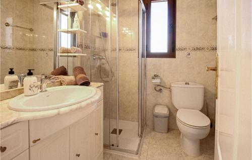 a bathroom with a toilet and a sink and a shower at 2 Bedroom Beautiful Apartment In Rojales in Rojales