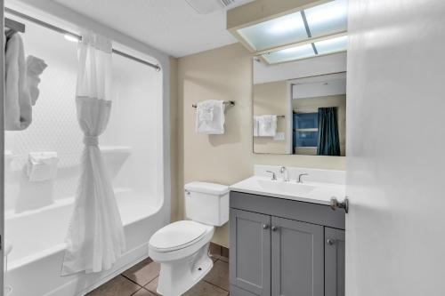 a bathroom with a toilet and a sink and a shower at Atlantica Beachfront Getaway in Myrtle Beach