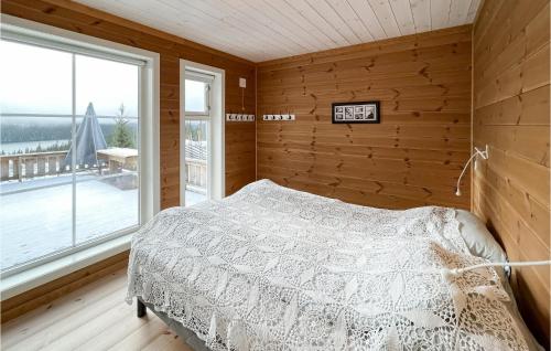 a bedroom with a bed and a large window at Stunning Home In Nord Torpa With Wifi in Nord Torpa