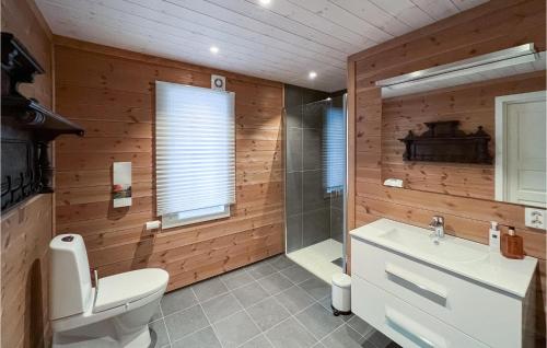 a bathroom with a toilet and a shower and a sink at Stunning Home In Nord Torpa With Wifi in Nord Torpa