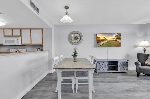 a kitchen and dining room with a table and chairs at Atlantica Beachfront Getaway in Myrtle Beach
