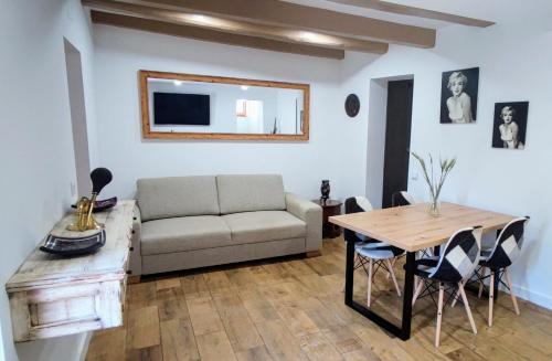 a living room with a couch and a table at La Bombonera del Berguedà in Sant Jordi de Cercs