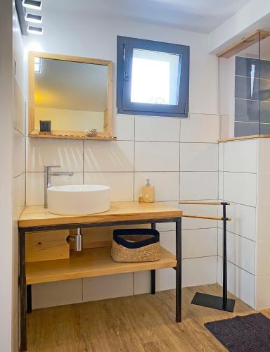a bathroom with a sink and a mirror at La Villa Hossegor in Hossegor