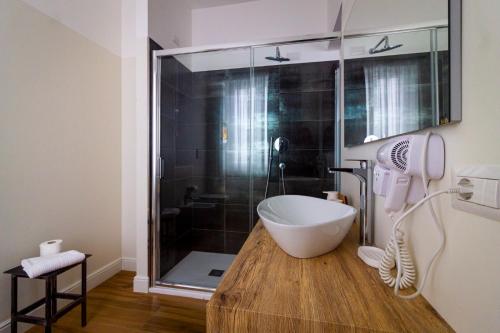 a bathroom with a shower with a bath tub at COMÓ EXCLUSIVE in Aprilia
