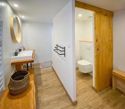 a bathroom with a sink and a toilet at La Villa Hossegor in Hossegor