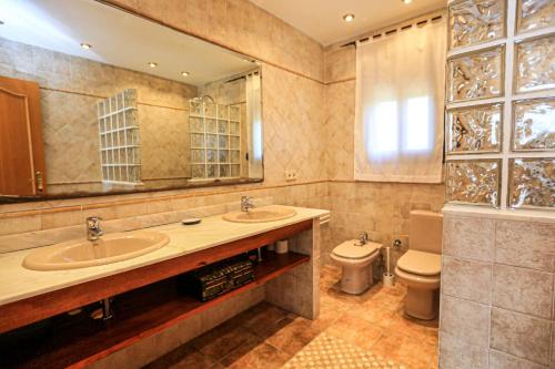 ein Badezimmer mit zwei Waschbecken und einem WC in der Unterkunft La Higuerita ONLY FAMILES in Vila-seca de Solcina