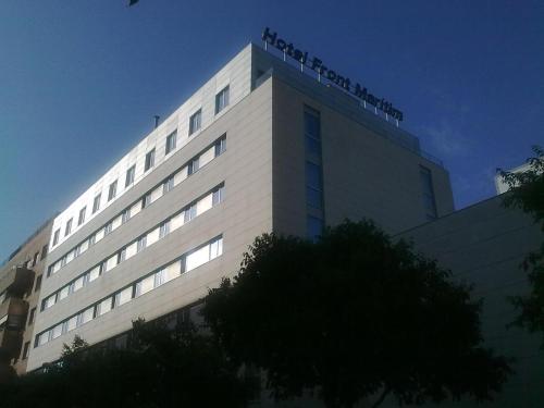 a tall white building with a sign on top of it at Hotel Best Front Maritim in Barcelona