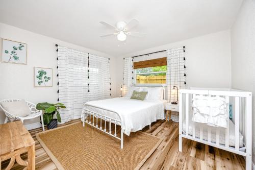 a white bedroom with a bed and a window at 7 People 4 Beds - 8 mins to beach by car - 2 mins to downtown - MODERN in Largo