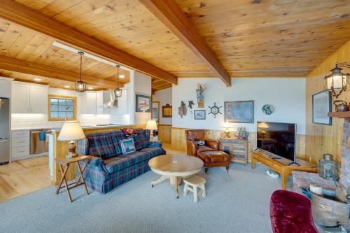 a living room with a couch and a table at Serene Island Retreat with Beach Access and Mtn Views! in Freeland