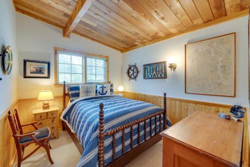 a bedroom with a bed and a wooden ceiling at Serene Island Retreat with Beach Access and Mtn Views! in Freeland