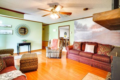 a living room with couches and a ceiling fan at Charming Lake Charles Home with Patio and Grill in Lake Charles