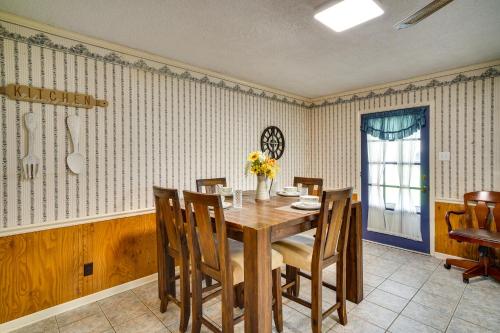 a dining room with a wooden table and chairs at Charming Lake Charles Home with Patio and Grill in Lake Charles