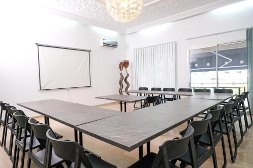 a conference room with a large table and chairs at Villa Ayaba in Abidjan