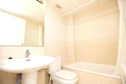 a bathroom with a sink and a toilet and a tub at 2 bedrooms apartement at Denia 300 m away from the beach with shared pool and furnished terrace in Denia
