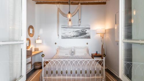 a small bedroom with a bed and a chandelier at villa lord in Pollonia
