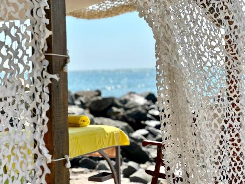 a table with a yellow table cloth on a beach at Ipanema Beach - Menada Apartments in Sveti Vlas