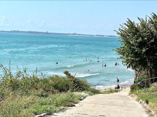 a group of people in the water at a beach at Ipanema Beach - Menada Apartments in Sveti Vlas