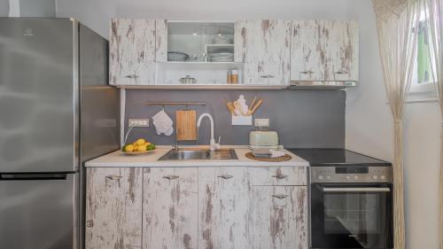 a kitchen with a sink and a refrigerator at villa lord in Pollonia