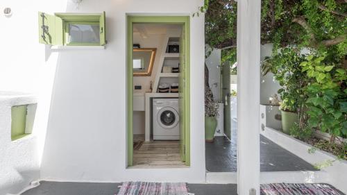 a door to a laundry room with a washing machine at villa lord in Pollonia