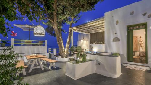 a patio with a table and a tree at night at villa lord in Pollonia