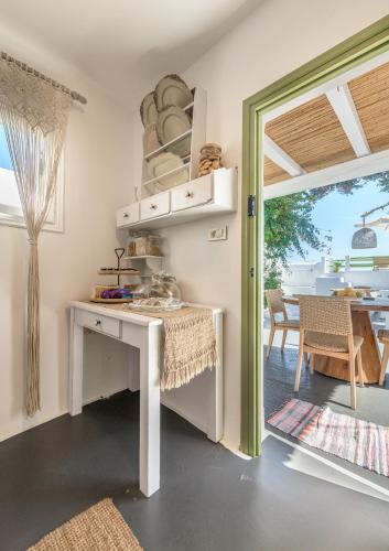 a kitchen with a white table and a dining room at villa lord in Pollonia