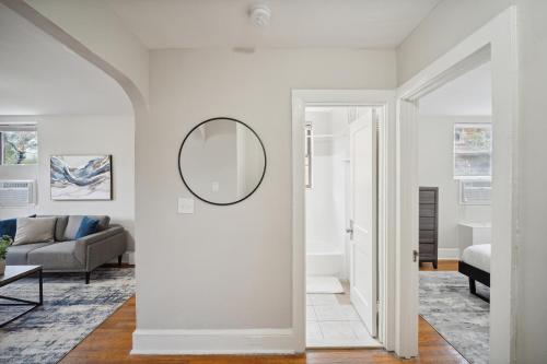 a white living room with a mirror and a couch at Peaceful & Perfect Private 1-br I Lennox in Philadelphia