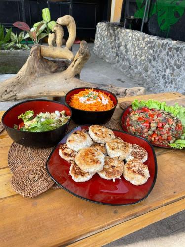 a table with plates of food and bowls of food at Happy Spiritus Guethouse Tabanan in Tabanan