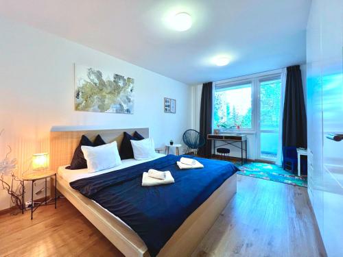 um quarto com uma cama azul com dois sapatos em Jana's apartment, free parking em Praga