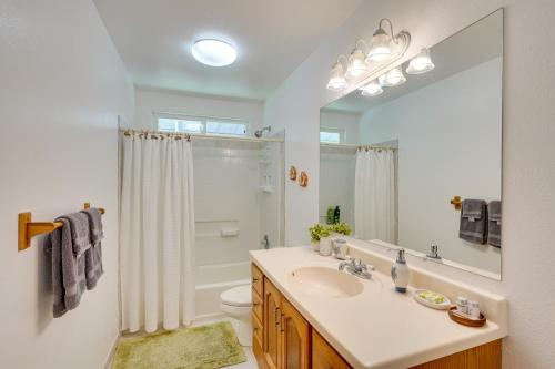 a white bathroom with a sink and a shower at Captain Cook Home on Quiet 3 Acres with Fruit Trees in Papa Bay Estates