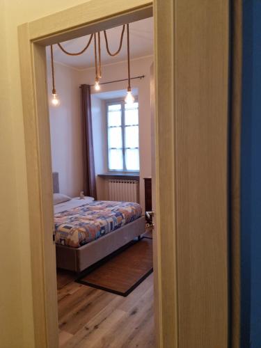 a bedroom with a bed and a window at ANTICA FILANDA Lattes in Cuneo