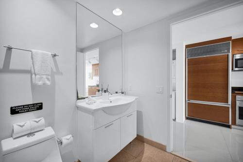 a white bathroom with a sink and a toilet at Stylish Studio Icon, W Hotel Waterfront Building in Miami