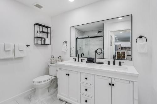 a bathroom with a sink and a toilet and a mirror at Corpus Christi Charm in Corpus Christi