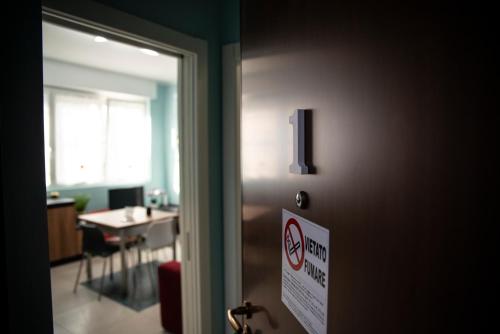 uma porta com um sinal de não fumadores num quarto em Casa Fulvia em Rozzano