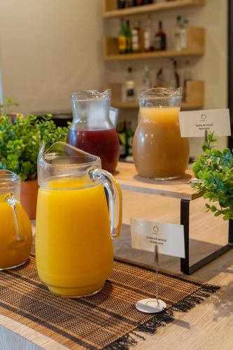 a display of different types of honey and orange juice at Lavanda Hotel Miravillas in Praia de Mira