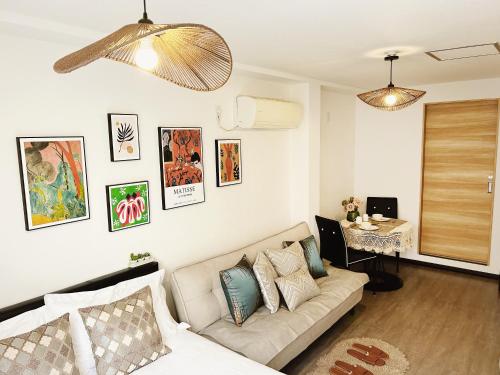 a living room with a couch and a table at Tokyo Louis House in Ueno area close to JR Yamanote Line & Metro Ginza Line walk to Ueno Park and Ameyoko in Tokyo