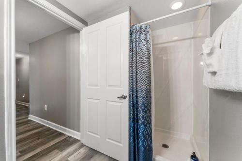 a closet with a white door and a blue tie at Shores of Panama #1921 by Nautical Properties in Panama City Beach