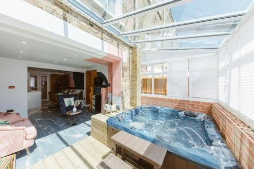 a large bathroom with a large tub in a room at Big House with En-suites a Big garden and Hot-tub near TOWER BRIDGE in London