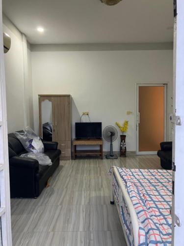 a living room with a couch and a tv at Ananta Canna in Phnom Penh