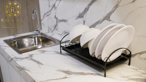 a plate rack on a counter next to a sink at Royal Suites Studio 15th Floor - Citra Plaza Nagoya Apartment in Nagoya