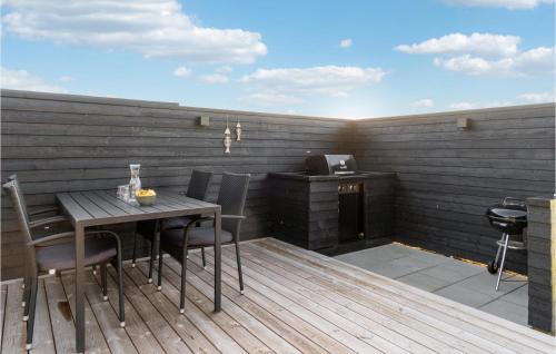 a patio with a table and chairs and a stove at Amazing Home In Glesborg With Wifi in Glesborg